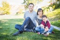 Happy Mixed Race Family Having Fun Outside on the Grass Royalty Free Stock Photo