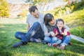 Happy Mixed Race Family Having Fun Outside on the Grass Royalty Free Stock Photo