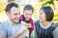 Laughing Mixed Race Family Having Fun Outside on the Grass Royalty Free Stock Photo