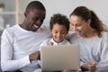 Happy mixed race family with little son enjoy using laptop Royalty Free Stock Photo