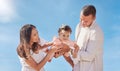 A happy mixed race family of three enjoying fresh air at the beach. Hispanic couple bonding with their newborn daughter Royalty Free Stock Photo