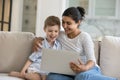 Happy mixed race family using computer at home. Royalty Free Stock Photo