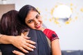 happy mixed race friends emracing hugging greeting each other in living room at home Royalty Free Stock Photo