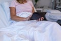 Happy mixed race mother and daughter sitting on the sofa,having fun and using laptop Royalty Free Stock Photo