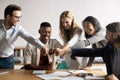 Happy mixed race older and younger colleagues bumping fists. Royalty Free Stock Photo