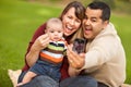 Happy Mixed Race Parents and Baby Boy with Camera