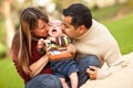 Happy Mixed Race Parents Playing with Their Son