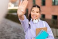 Happy mixed race student girl giving high five celebrating success and passed exam, standing in college campus outdoors Royalty Free Stock Photo