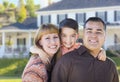 Happy Mixed Race Young Family in Front of House Royalty Free Stock Photo