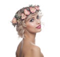 Happy model woman with blonde curly hair, makeup and flowers crown smiling isolated on white background Royalty Free Stock Photo