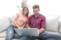 Happy modern couple surfing the net and working on laptop at home Royalty Free Stock Photo