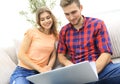 Happy modern couple surfing the net and working on laptop at home Royalty Free Stock Photo