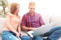 Happy modern couple surfing the net and working on laptop at home Royalty Free Stock Photo