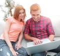 Happy modern couple surfing the net and working on laptop at home Royalty Free Stock Photo