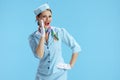 happy modern female flight attendant on blue sharing good news