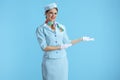 happy modern flight attendant woman on blue welcoming