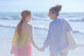 Happy modern mother and child at beach having fun time Royalty Free Stock Photo