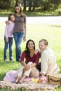 Happy modern multicultural family enjoying picnic Royalty Free Stock Photo