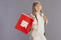 happy modern pupil in beige tracksuit with shopping bag