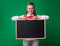 Happy modern student woman in headphones showing blackboard