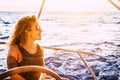 Happy modern and trendy caucasian woman portrait enjoy trip and tour on sail boat in summer holiday vacation leisure activity - Royalty Free Stock Photo