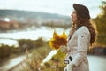 Happy modern woman in beige trench coat and black beret Royalty Free Stock Photo