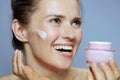 happy modern woman with cosmetic cream jar Royalty Free Stock Photo