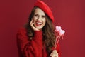 happy modern woman in red sweater and beret with hearts on stick Royalty Free Stock Photo