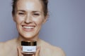 happy modern 40 years old woman with cosmetic cream jar Royalty Free Stock Photo