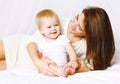 Happy mom and baby having fun in bed at home Royalty Free Stock Photo