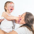 Happy mom and baby playing with painted face by paint Royalty Free Stock Photo