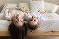 Happy mom and cheerful cute toddler girl upside down heads Royalty Free Stock Photo