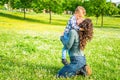 Happy mom and child chilling in public park garden in summer.mother and son relaxing toghether outdoor sitting on grass playing. Royalty Free Stock Photo