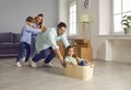 Happy mom, dad and little children playing and having fun in their new house or apartment Royalty Free Stock Photo