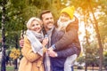 Happy mom, dad and son playing having fun together, walking at the autumn park, hugging, smiling Royalty Free Stock Photo