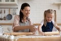 Happy mom and daughter baking pie at home together Royalty Free Stock Photo