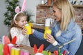 Happy mom and daughter playing with handmade Easter chickens Royalty Free Stock Photo