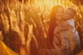 Happy Mom with Her Little Son Enjoying Summer Weekend Outside the City in the Field at Sunny Day Sunset. Young mother playing, Royalty Free Stock Photo