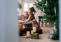 happy mom hugs her little daughters sitting on the floor near the Christmas tree. Royalty Free Stock Photo