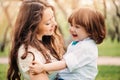 Happy mom hugs and kiss toddler kid son outdoor in spring or summer Royalty Free Stock Photo