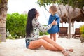 Happy mom and kid enjoying time together at the white beach Royalty Free Stock Photo