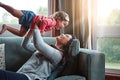 Happy, mom and lifting girl on sofa in home living room and relax, bonding and quality time together or mother, love and Royalty Free Stock Photo