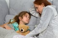 Mom sitting on couch with daughter