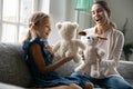 Happy mom and small daughter play with toys Royalty Free Stock Photo