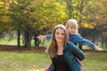 Happy mom with a smile playing with her daughter in the park on a summer day Royalty Free Stock Photo