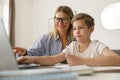 Happy mom and son doing homework and studying with laptop together. Home education Royalty Free Stock Photo