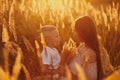 Happy mom with son in the field at sunset. happy childhood. A young woman hugs her son Royalty Free Stock Photo