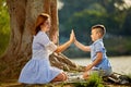 Happy mom and son play in the park in spring. Mother Talking to her son in the park Royalty Free Stock Photo