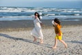 Happy mom and son  running on the beach Royalty Free Stock Photo