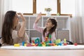 Happy mom and sweet preschool child girl giving high five Royalty Free Stock Photo